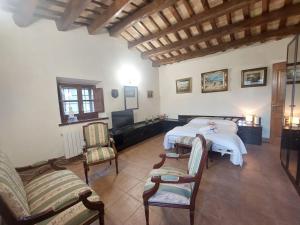 ein Schlafzimmer mit einem Bett und Stühlen in einem Zimmer in der Unterkunft Casa Santa Cristina d'Aro, 5 dormitorios, 10 personas - ES-209-57 in Santa Cristina d'Aro