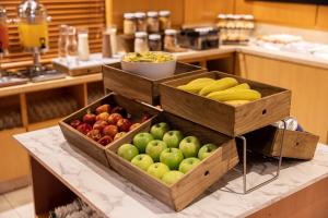 two wooden bins of apples and bananas on a counter at Holiday Inn Express Puerto Madero, an IHG Hotel in Buenos Aires