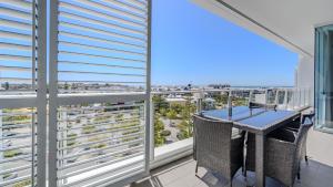 a balcony with a table and a view of the city at Bayview 701 in Mandurah