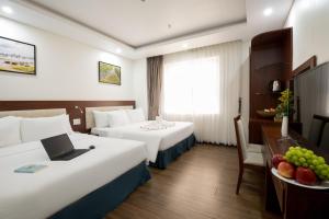 Postel nebo postele na pokoji v ubytování Dao Ngoc Hotel Da Nang + 37 fotografií