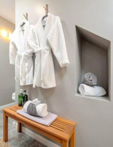 a room with white coats hanging on a wall at 2MBR/2.5BA, easy access, hot tub, firepit, arcade. jacuzzi in Pigeon Forge