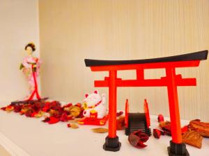 a red chair sitting on top of a table with toys at Hiroshima 広島 at Anderson in Surabaya
