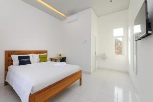 Кровать или кровати в номере Urbanview Hotel Betego Syariah Enggal