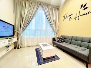 a living room with a couch and a tv at Melaka AmberCove Homely Seaview 2R2B in Malacca
