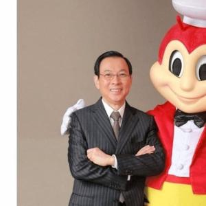 a man in a suit standing next to a stuffed monkey at Hanalei homes robinsons home laoag city ilocos norte in Bangued