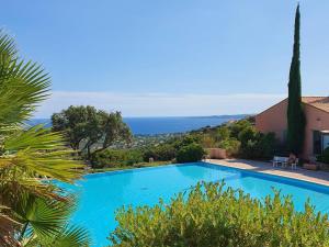 a blue swimming pool with a view of the ocean at Villa Les Issambres, 3 pièces, 6 personnes - FR-1-768-21 in Les Issambres