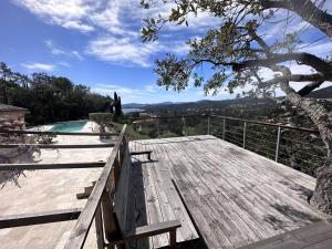 a wooden deck with a view of the mountains at Villa provençale avec piscine privée, clim, Wi-Fi, jardin, 5 chambres - FR-1-768-20 in Les Issambres