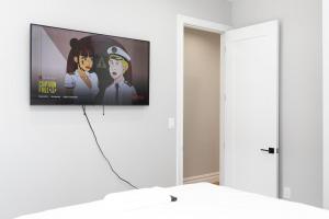 a tv hanging on a wall in a room at Misbau home in Brooklyn