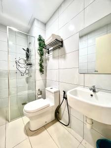 a white bathroom with a toilet and a sink at Melaka AmberCove Homely Seaview 2R2B in Malacca