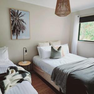 a bedroom with two beds with a dog laying on them at Eight Acres Lakes Entrance in Lakes Entrance