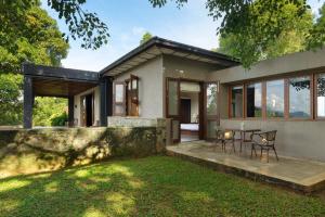 a home with a patio and grass yard at Mount Havana in Kandy