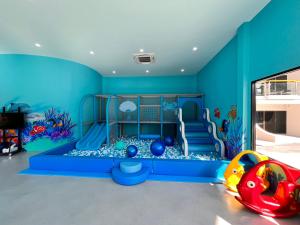 a childs play room with a blue wall at Amora Beach Resort Phuket - SHA Extra Plus in Bang Tao Beach