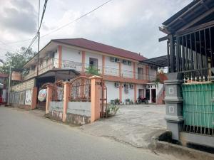 a building on the side of a street at OYO 93332 Kharis Home Stay in Jayapura