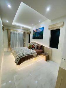 a bedroom with a bed and a flat screen tv at Krabi Aonang & Alpha villa in Ao Nam Mao