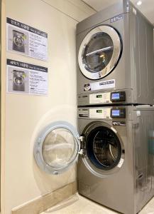 a washing machine and a dryer in a room at Hotel Prince Seoul in Seoul