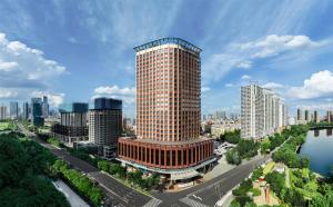 a tall building in the middle of a city at Swissôtel Shenyang in Shenyang