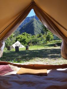 a view of a tent with a mountain in the background at La Pause Mafate in La Possession