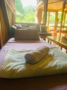 a hotel room with two beds with towels on them at Palayan Villa - Villa with views, garden and jacuzzi in El Nido