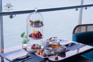 a table with a tray of food in a bird cage at Queen Ann Nha Trang Hotel in Nha Trang