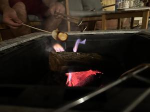 a man is cooking meat on a grill at Al Khaldiyyah Nights Studio in Riyadh