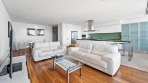 a living room with a white couch and a table at Seapoint 102 in Mandurah