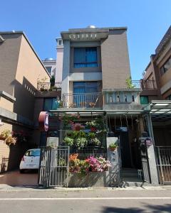 a building with flowers in front of it at Bestime B&B in Jiji