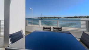 a blue table and chairs with a view of the water at Seapoint 109 in Mandurah