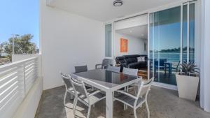 a dining room with a table and chairs at Seapoint 109 in Mandurah