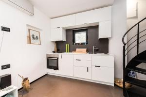 a kitchen with white cabinets and a staircase at Villa Gordan - Happy Rentals in Dragove