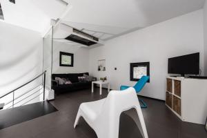 a white living room with a couch and a tv at Villa Gordan - Happy Rentals in Dragove