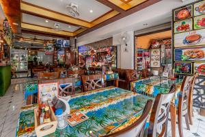 a dining room with tables and chairs and a restaurant at Patong Social Hotel & Restaurant in Patong Beach
