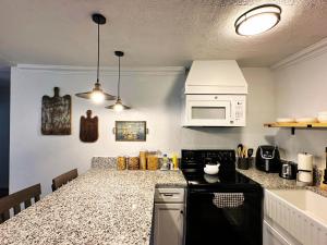 a kitchen with a counter top and a microwave at 2br Newly Renovated House I Weekend Escape in Oklahoma City