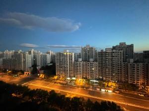 a view of a city at night with buildings at Beijing Lesiure Aparment - 200M from Exit D of Line 6 in CBD in Beijing