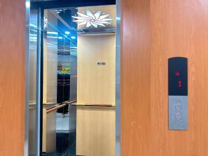 a elevator with a door with a sign on it at Milan Homestay - Milanesa Hotel and Apartment in Vung Tau