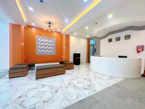 a lobby with a reception desk and a marble floor at Milan Homestay - Milanesa Hotel and Apartment in Vung Tau