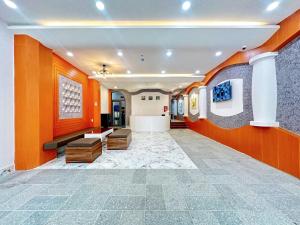 a lobby of a building with orange walls at Milan Homestay - Milanesa Hotel and Apartment in Vung Tau