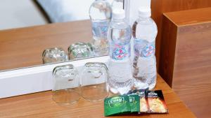 a group of water bottles and glasses on a table at Milan Homestay - Milanesa Hotel and Apartment in Vung Tau