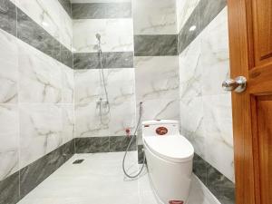 a bathroom with a toilet and a shower at Milan Homestay - Milanesa Hotel and Apartment in Vung Tau