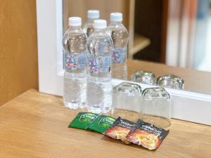 a group of bottles of water and snacks on a counter at Milan Homestay - Milanesa Hotel and Apartment in Vung Tau