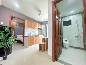 a bathroom with a shower and a toilet and a sink at Milan Homestay - Milanesa Hotel and Apartment in Vung Tau