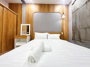 a bedroom with a large bed with white sheets at Milan Homestay - Milanesa Hotel and Apartment in Vung Tau
