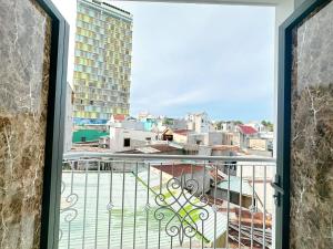a balcony with a view of a city at Milan Homestay - Milanesa Hotel and Apartment in Vung Tau