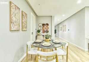 a dining room with a glass table and white chairs at bnbmehomes - Modern 2 BR w Pvt Entrance Riyadh - 3C in Riyadh