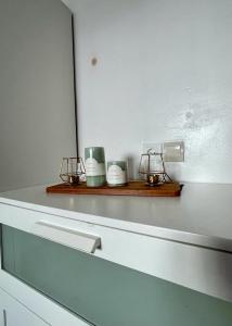 a kitchen counter with three candles on a shelf at Quartier Administratif in Tetouan