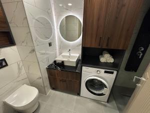 a bathroom with a washing machine and a sink at Hilloria Residence in Serdivan