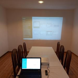 a laptop computer sitting on a table in front of a screen at Vallombre natiora 