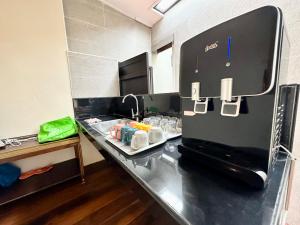 a kitchen with a counter with drinks on it at Madras Inn 58-1 Private Bathroom in George Town