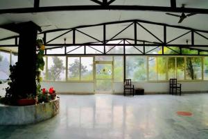 a large room with a large group of windows at Shiv Shakti Yogpeeth Cottages in Rishīkesh