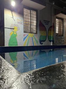 a swimming pool with a painting on the wall at Ladakh House- 3 BHK Ladakh themed Villa near Matheran in Neral