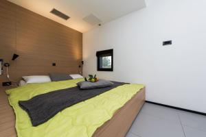a bedroom with a large bed with a yellow blanket at Villa Sun House - Happy Rentals in Dragove